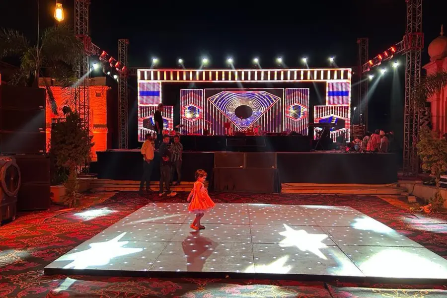 A view of beautifully lit dance floor at The Earth, Amritsar during a vibrant evening event, capturing the hotel’s festive ambiance.