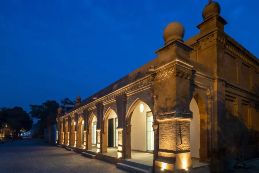 Historic brick arches of The Earth Amritsar beautifully lit under the evening sky, highlighting its heritage elegance.